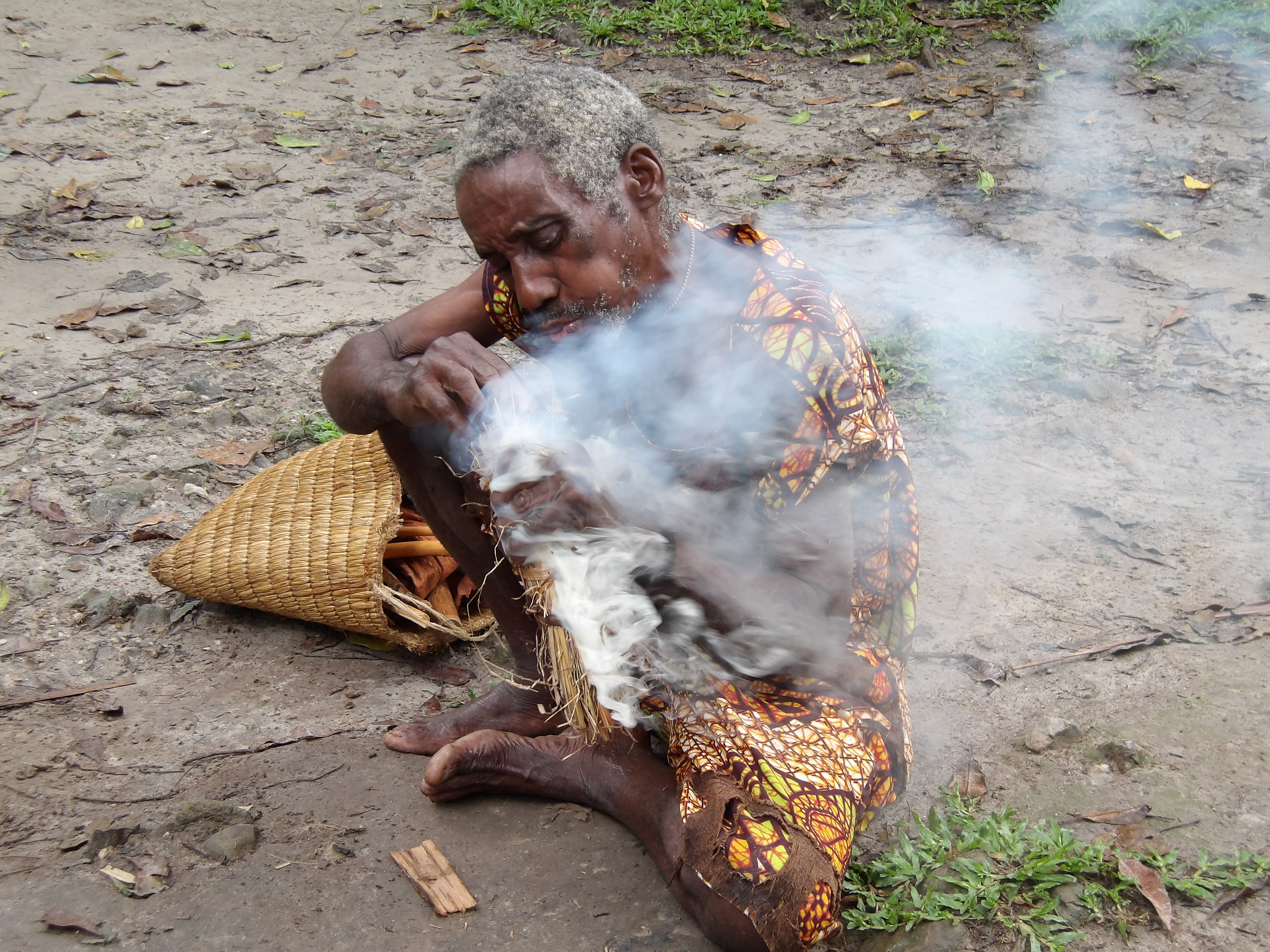 man making fire with smoke in front of his face