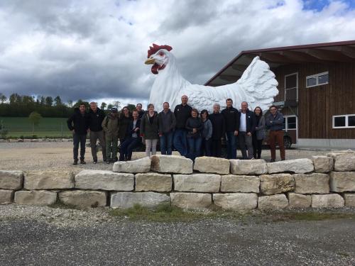 dr. blatchford and a group of people from the north american poultry industry standing in front of a large chicken structure