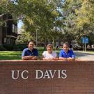 jesus smiling with his parents at the brick UC Davis sign near Dutton Hall